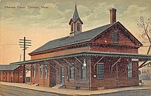 A postcard showing a two-story wooden train station