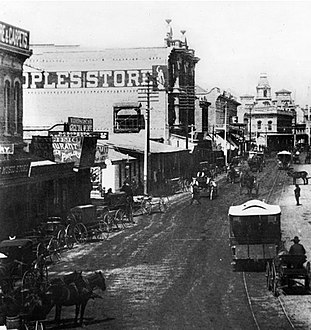 Looking northeast on Spring Street from First Street, 1880s. Asher Hamburger's Peoples Store at center. Towers of the Baker Block are visible in the distance.