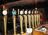 A series of draught beers on tap.