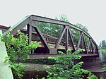 A relatively small steel bridge seen from the side.