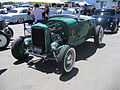 Hi-boy Deuce roadster with flatty (with factory head and exhaust but aftermarket alternator ignition and dual-carb intake), dropped tube axle, and drum brakes.