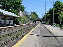 A train station with low-level side platforms