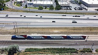 A Freeway next to a Regional Passenger Train