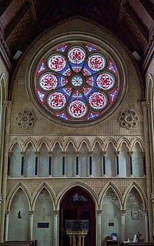 The rose window of St. Mary's church, at Itchen Stoke, Hampshire, England. September 2024.