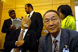 A seated Karpal with four other people