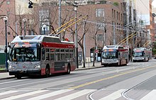 Three trolleybuses on a city street