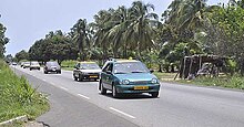 a picture of a green taxi in motion