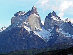 A laccolith of granite (light-coloured) that was intruded into older sedimentary rocks (dark-coloured) at Cuernos del Paine, Torres del Paine National Park, Chile