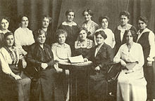 Black and white photograph of two rows of women posing for the picture.