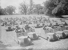 Photograph of a parade of Standard Beaverette reconnaissance cars and their drivers