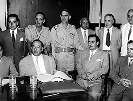 Photograph of Qasim and other leaders of the revolution, including Abdul Salam Arif and Muhammad Najib ar-Ruba'i. Also included is Ba'athist ideologue Michel Aflaq.