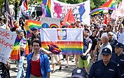 Staszewski (left) carries a rainbow version of the Polish flag at the 2018 Częstochowa equality march