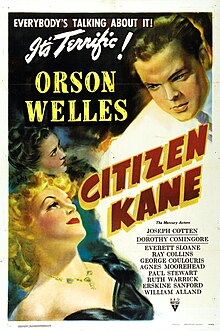 Poster showing two women in the bottom left of the picture looking up towards a man in a white suit in the top right of the picture. "Everybody's talking about it. It's terrific!" appears in the top right of the picture. "Orson Welles" appears in block letters between the women and the man in the white suit. "Citizen Kane" appears in red and yellow block letters tipped 60° to the right. The remaining credits are listed in fine print in the bottom right.