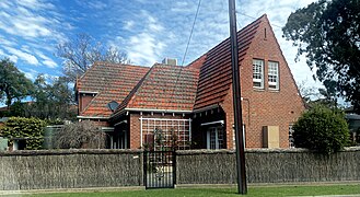 House in Lockleys with two distinguishing features that characterise Adelaide houses: a brush fence and red brick veneer.