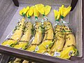 Individual bananas inside plastic bags