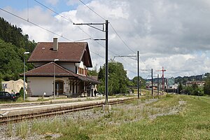 Two-story chalet-style building next to railway line