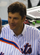 Robin Ventura, wearing a blue pinstripe jersey with the words METS partially cut off, converses with a fellow player