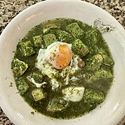 Broth and a poached egg completes the dish