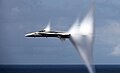 Complex set of condensation cones surround a F/A-18 at transonic speed