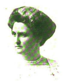 B&W portrait photo of woman with hair in an up-do, wearing a pale-colored blouse.