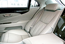 View of a car rear seat with leather ottoman.