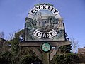 Cockley Cley village sign, showing the church still with its tower