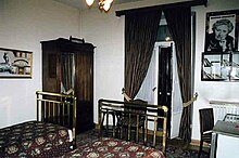 Colour photograph of a hotel room with Christie memorabilia on the walls