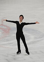 A photograph of Nathan Chen performing on the ice.