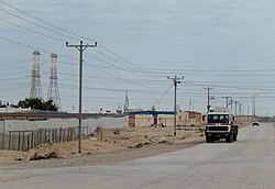 Road in Umm Al Qahab dominated by power lines