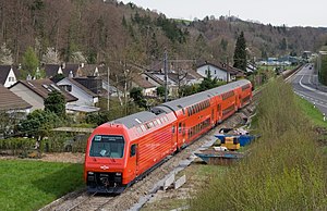 Red train with double-deck coaches