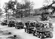 U.S. Army trucks loaded with steel-helmeted federal agents roll across the University of Mississippi campus
