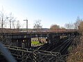 To the east of the station, the former railway line crosses over the North Clyde Line.