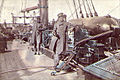 Captain Raphael Semmes, Alabama's commanding officer, standing aft of the mainsail by his ship's aft 8-inch smooth bore gun during her visit to Cape Town in August 1863. His executive officer, First Lieutenant John M. Kell, is in the background, standing by the ship's wheel.[9]