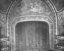 Black-and-white image of the auditorium's proscenium arch, which contains murals