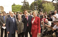 Vladimir Putin, Paul McCartney, and Heather Mills surrounded by reporters and photographers.