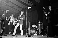 Five men performing instruments