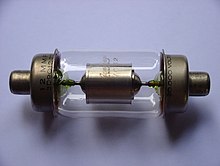 A glass cylinder capped on both ends with metal electrodes. Inside the glass bulb there is a metal cylinder connected to the electrodes.