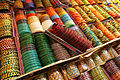 Image 10 Bangles Photograph: Muhammad Mahdi Karim Bangles on display in Bangalore, India. These rigid bracelets are usually made from metal, wood, or plastic and are traditionally worn by women in India, Nepal, Pakistan, and Bangladesh. In India, it is a common tradition to see a new bride wearing glass bangles at her wedding and the honeymoon will end when the last bangle breaks. More selected pictures