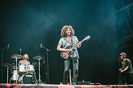 Wolfmother performing in 2018. From left to right: Hamish Rosser, Andrew Stockdale, Brad Heald