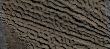 Close view of lineated valley fill (LVF) in valley, as seen by HiRISE under HiWish program. Linear valley flow is ice covered by debris. Picture is about 1 km wide.