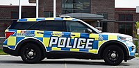 A Ford Explorer police cruiser with yellow-and-blue Battenburg markings in St. Thomas, Ontario.