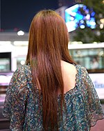 A Japanese woman with mid-back length hair