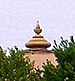 A photograph of a golden, symmetrical sculpture.