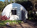Fiberglass dome cottage in Davis, California. This dome was built in 1972 and is part of the Baggin's End student housing cooperative.