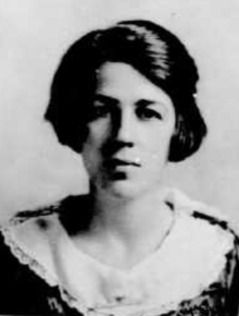 A young white woman with bobbed dark hair, wearing a round white collar in her passport photo