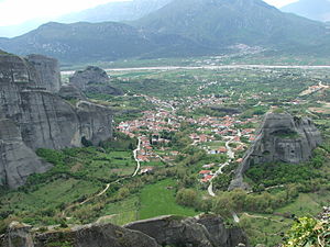 View of Kastraki from the Meteora rocks. In the distance is the Pineios River. Upstream is to the right. To the left is Kalabaka. The edge of Holy Spirit Rock is on the right. Surloti Rock is the second-to-last one on the left.