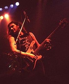 Lemmy onstage playing bass guitar