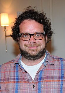 A smiling, bespectacled Christophe Beck
