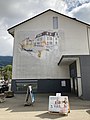 Mural on the site of the former CCB terminus at Blonay. The caption reads 'Upon this spot from 1911 to 1955, a tram line linked Blonay to Clarens. On the 1 January 1956, the line was replaced by buses."