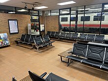 The interior of the waiting room of the Ann Arbor station will black seats.